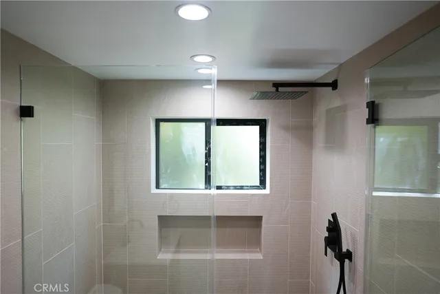 a bathroom with a window and a shower