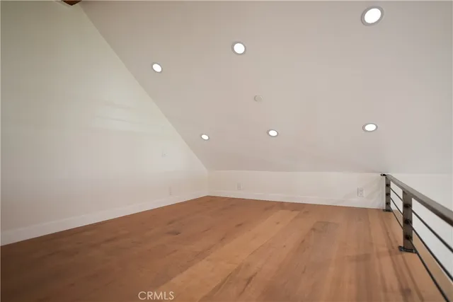 a view of a room with wooden floors and white walls