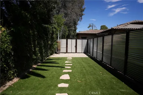 a view of swimming pool with a garden and deck