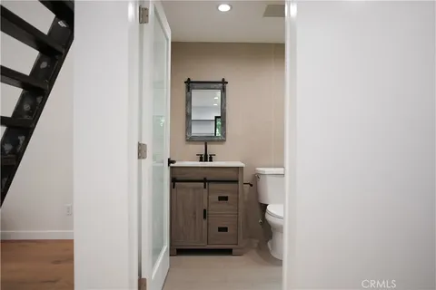a bathroom with a toilet a sink and mirror