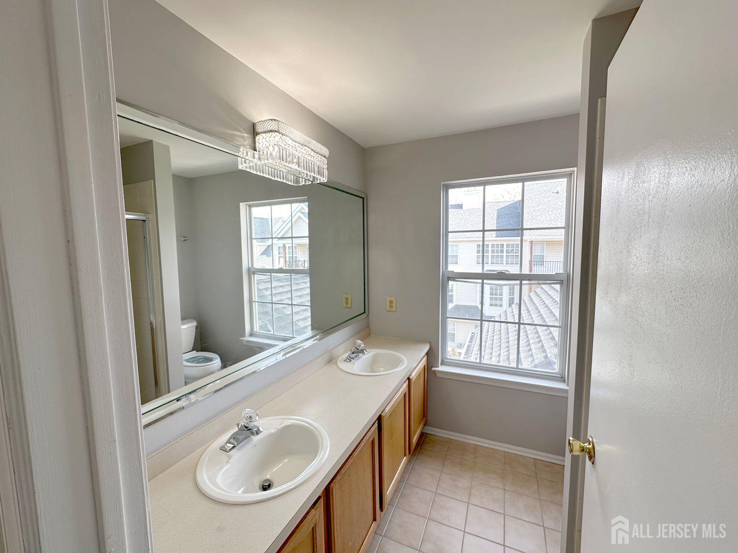 1212 Plymouth Road North Brunswick, NJ 08902 - Photo 25 of 27 a bathroom with a tub sink and mirror