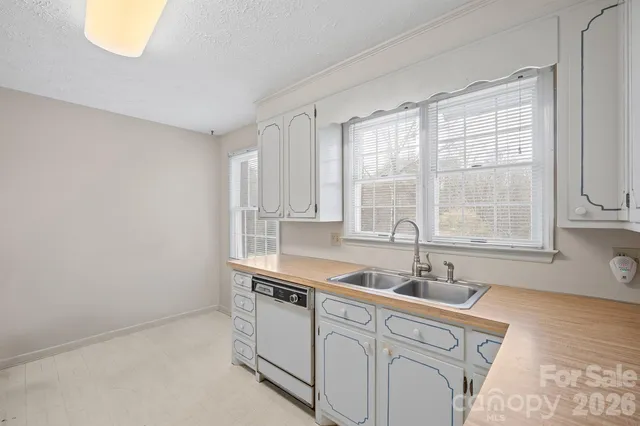 a kitchen with stainless steel appliances a sink a stove and a window