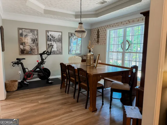 a view of a dining room with furniture window and wooden floor