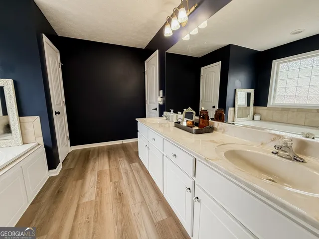 a spacious bathroom with a double vanity sink and a mirror
