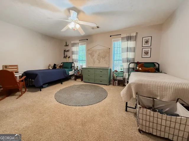 a bedroom with furniture and a chandelier