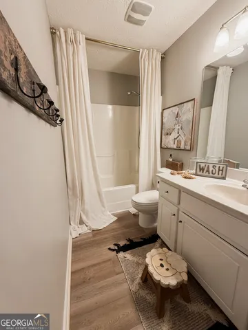 a bathroom with a sink mirror and toilet