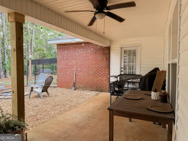 a backyard of a house with table and chairs