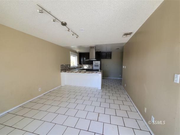 548 South Fairview Street Ridgecrest, CA 93555 - Photo 10 of 35 a kitchen with a sink a stove cabinets and utility room