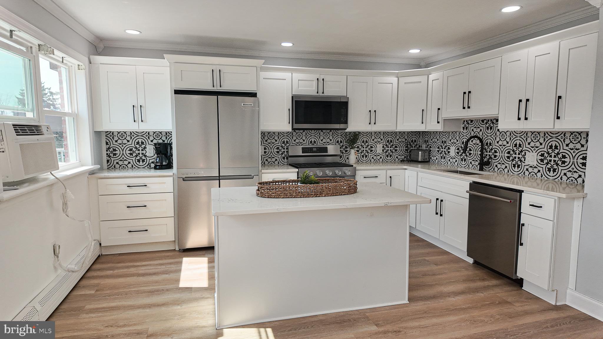 3503 Brookview Road Philadelphia, PA 19154 - Photo 7 of 30 a kitchen with stainless steel appliances kitchen island granite countertop a stove a sink and a refrigerator