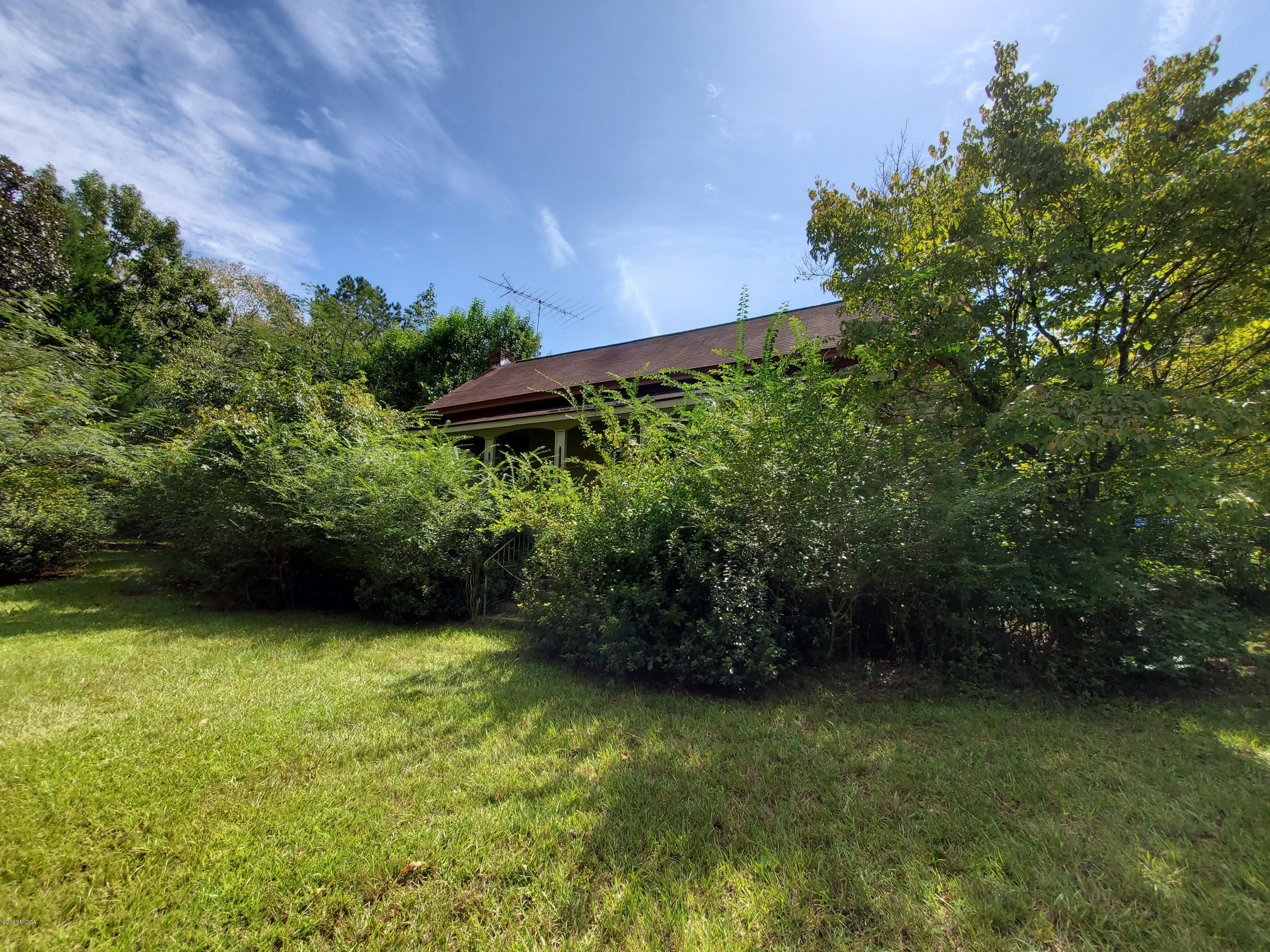 968 Rogers Church Road Forsyth, GA 31029 - Photo 2 of 14 a view of a yard with plants and a bench