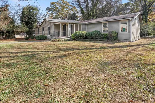 a front view of house with yard and green space