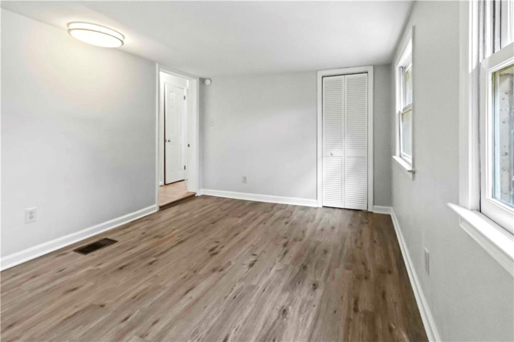 2314 Wayside Drive Brookhaven, GA 30319 - Photo 11 of 17 an empty room with wooden floor and windows