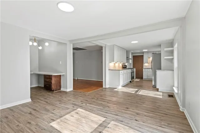 a kitchen with white cabinets and stainless steel appliances