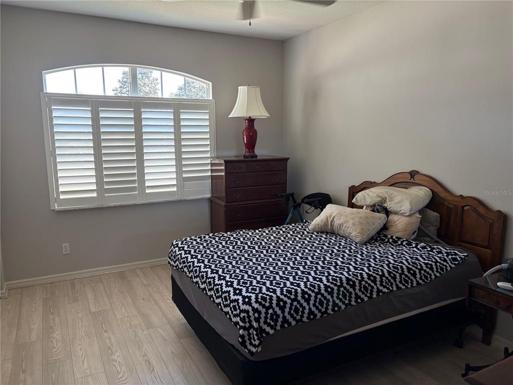 9288 Southwest 93rd Circle Ocala, FL 34481 - Photo 15 of 24 a bedroom with a bed and a window