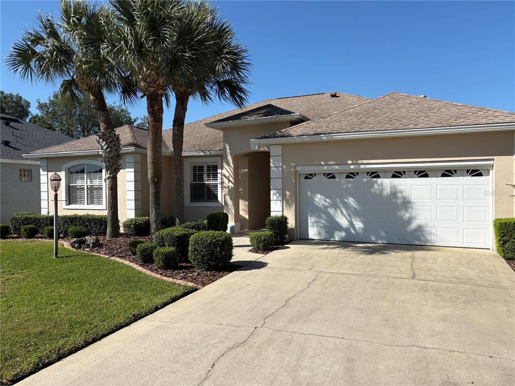 9288 Southwest 93rd Circle Ocala, FL 34481 - Photo 2 of 24 a front view of a house with a yard and garage