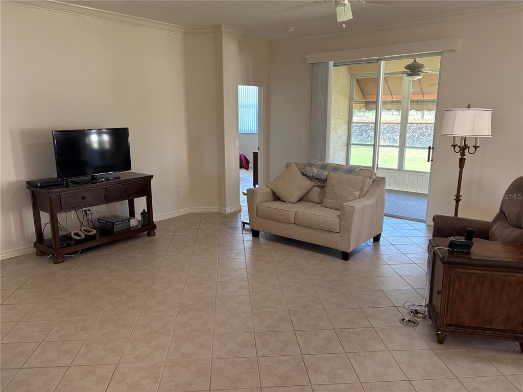 9288 Southwest 93rd Circle Ocala, FL 34481 - Photo 6 of 24 a living room with furniture and a flat screen tv