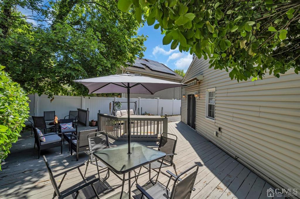 462 Old Post Road Edison, NJ 08817 - Photo 16 of 19 a patio with wooden floor table and chairs