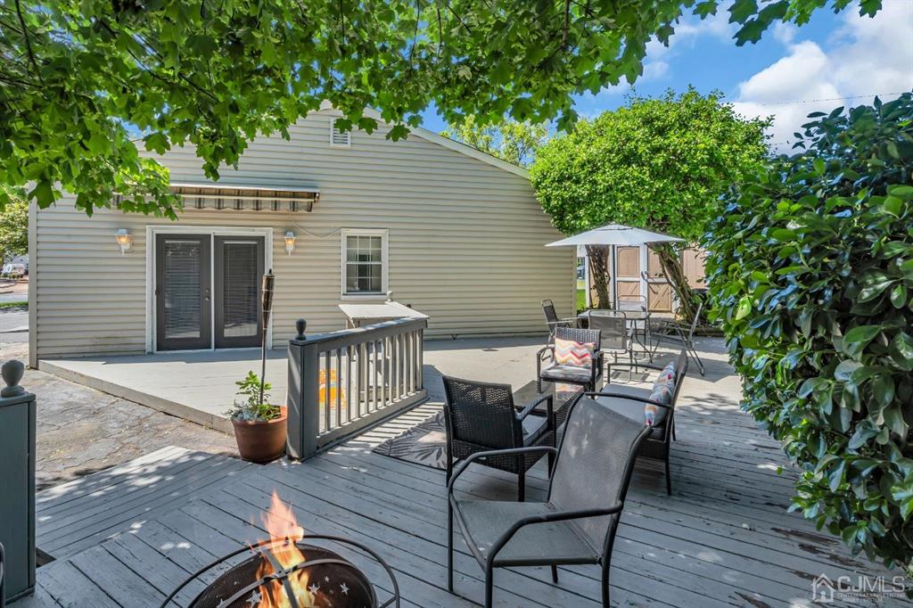462 Old Post Road Edison, NJ 08817 - Photo 17 of 19 a view of a patio with table and chairs with wooden floor and plants