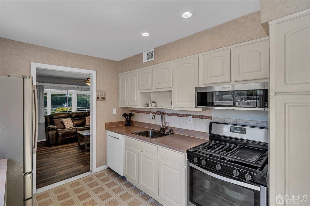 462 Old Post Road Edison, NJ 08817 - Photo 8 of 19 a kitchen with stainless steel appliances granite countertop a stove and a sink
