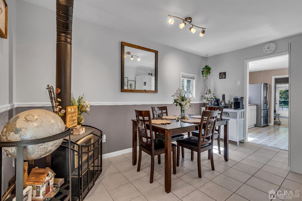 462 Old Post Road Edison, NJ 08817 - Photo 10 of 19 a view of a dining room and livingroom with furniture wooden floor a rug and a chandelier