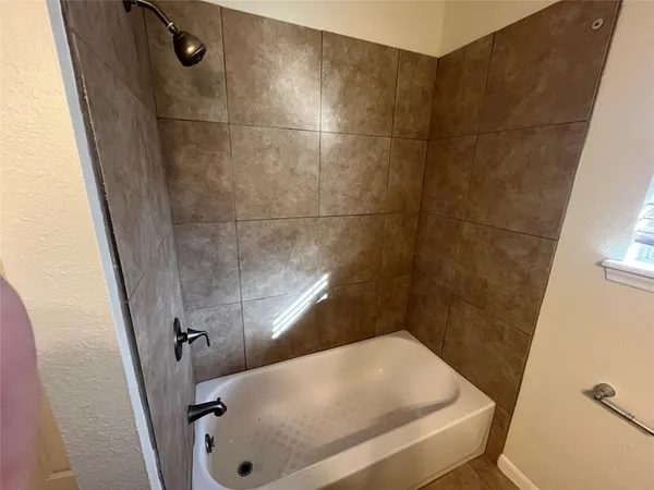 a bathroom with a tub and a shower