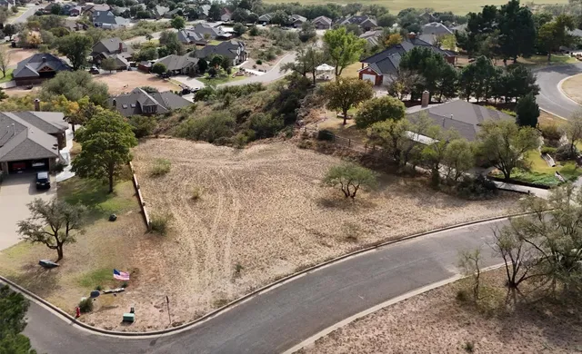 an aerial view of a residential houses with outdoor space