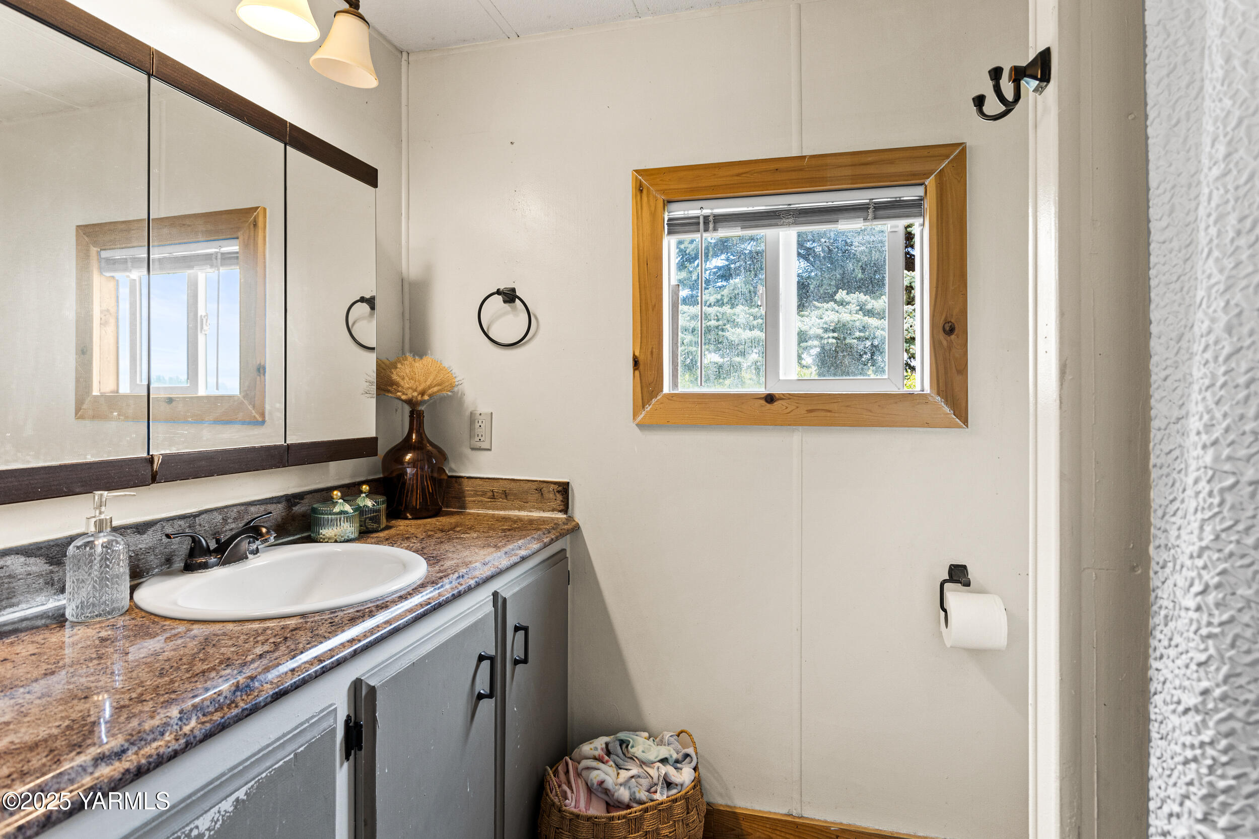 3050 Rosenkranz Road Tieton, WA 98947 - Photo 15 of 28 a bathroom with a granite countertop sink a mirror and a window