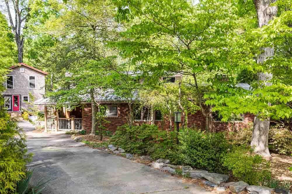a front view of a house with a yard and tree s