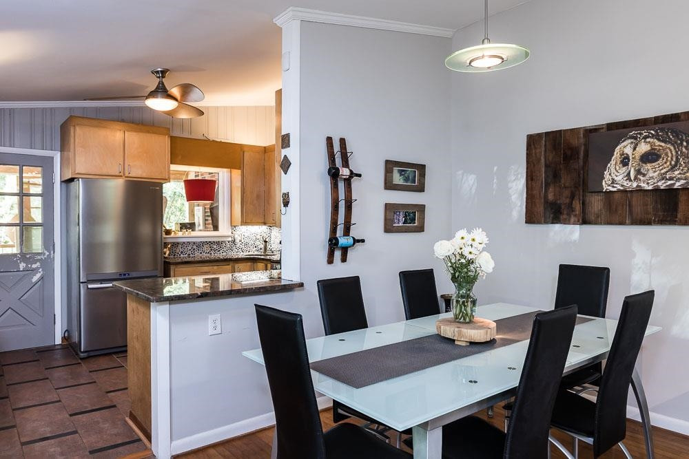 3604 Laurel Circle Raleigh, NC 27612 - Photo 11 of 59 a kitchen with a dining table and chairs
