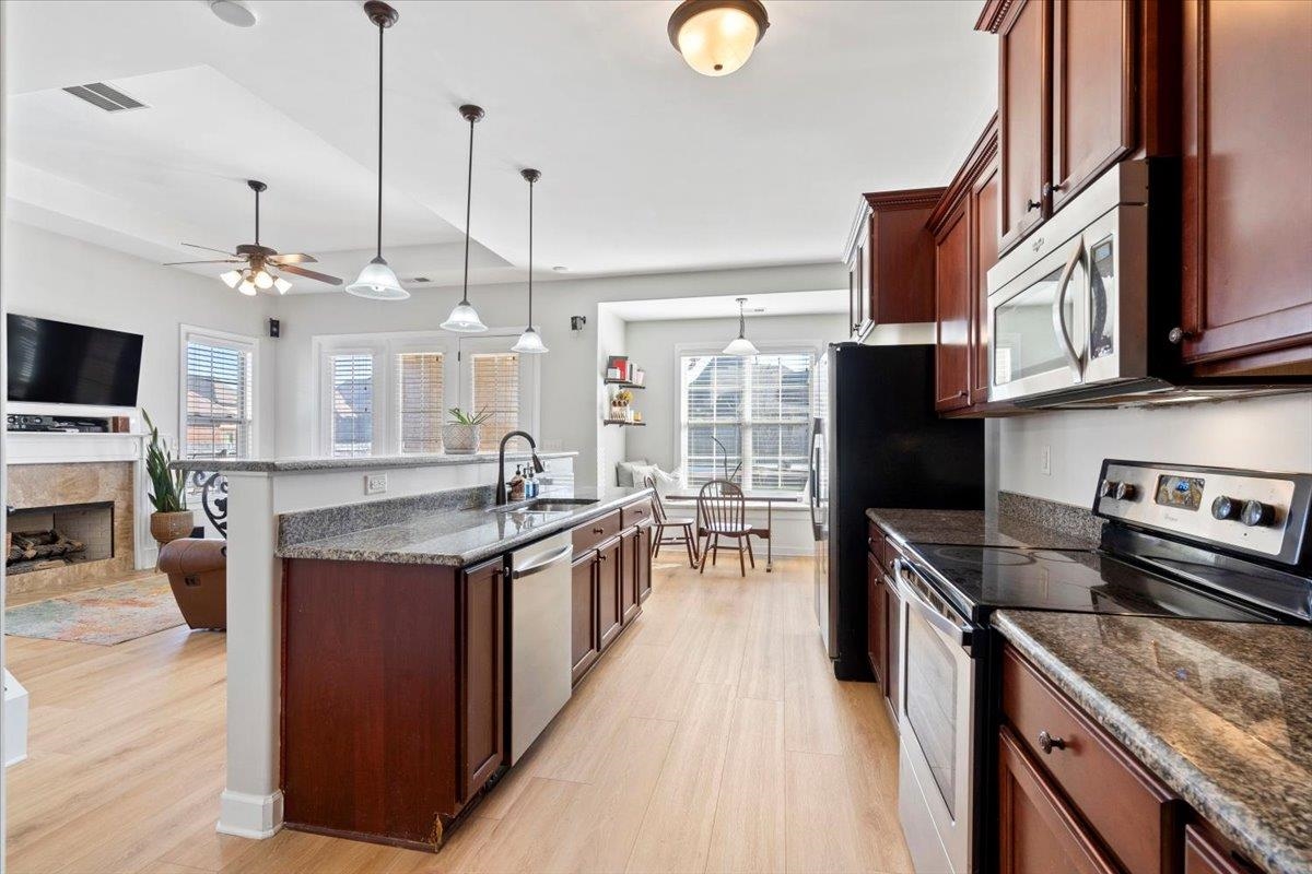 225 Estanaula Road Collierville, TN 38017 - Photo 11 of 38 a kitchen with stainless steel appliances granite countertop a stove oven and a refrigerator
