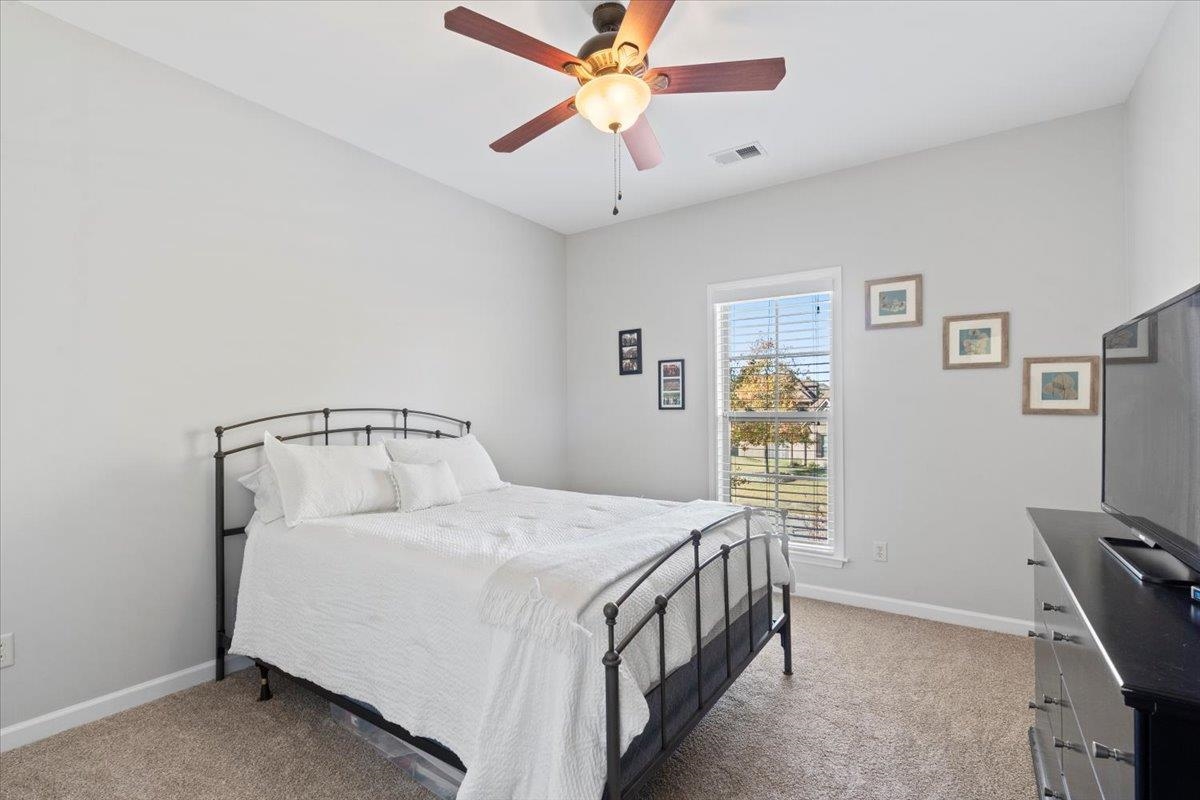 225 Estanaula Road Collierville, TN 38017 - Photo 23 of 38 a bedroom with a bed and a chandelier