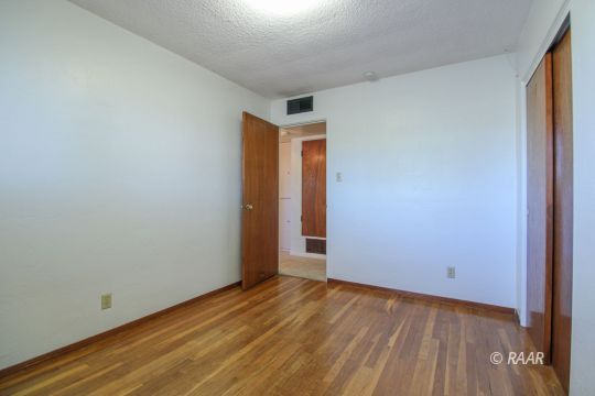 251 West Perdew Avenue Ridgecrest, CA 93555 - Photo 21 of 35 a view of an empty room with wooden floor and a window