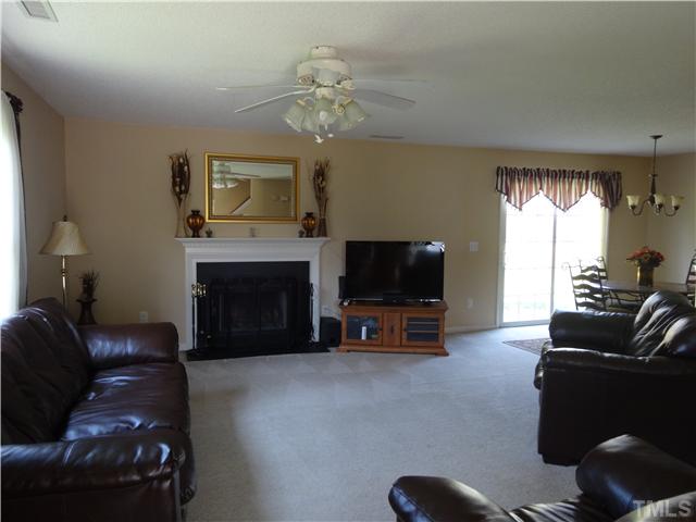2208 Tucca Way Raleigh, NC 27604 - Photo 3 of 18 a living room with furniture a fireplace and a flat screen tv