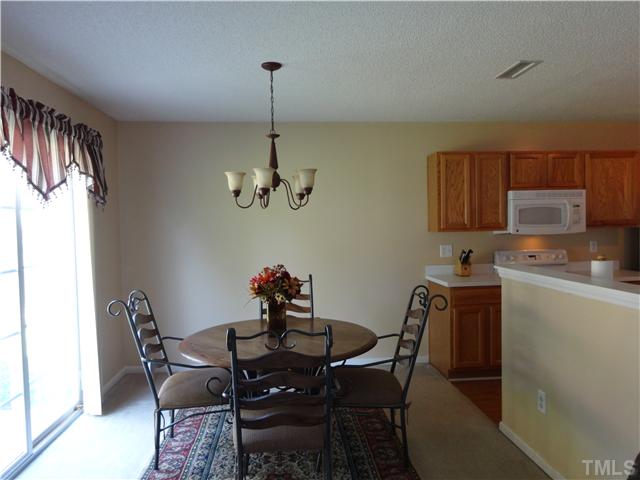 2208 Tucca Way Raleigh, NC 27604 - Photo 8 of 18 a view of a dining room with furniture window and wooden floor