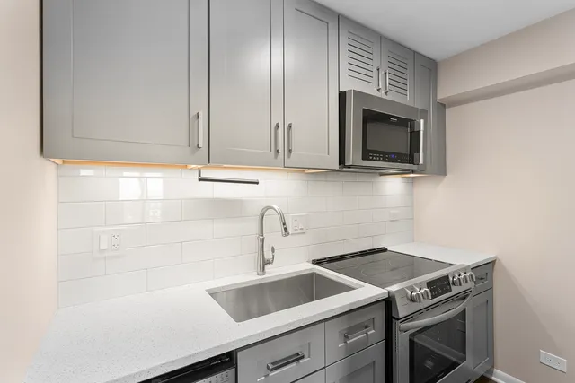 a kitchen with a sink and cabinets