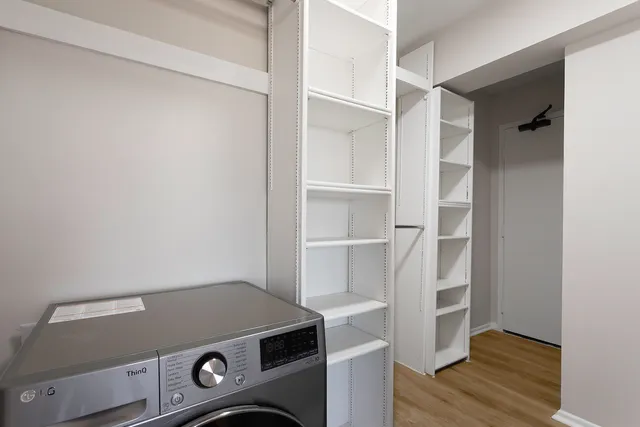 a view of an empty room with wooden floor