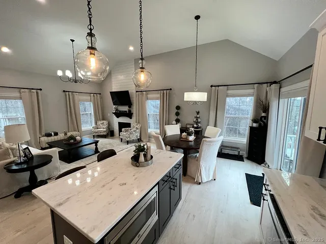 a large kitchen with a table and chairs