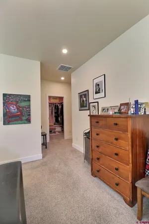 a bathroom with a granite countertop double vanity sink and a mirror
