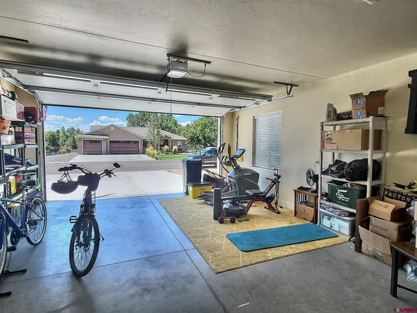 a view of a patio with table and chairs with wooden floor and fence