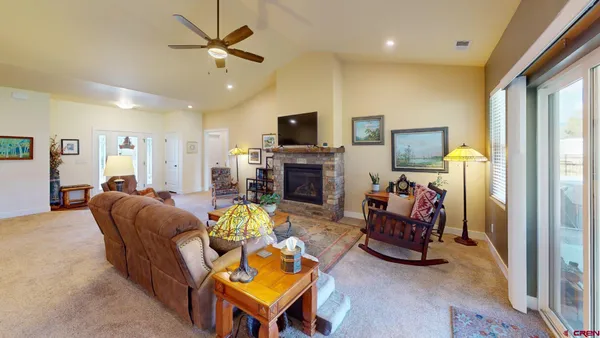 a living room with furniture a fireplace and a flat screen tv