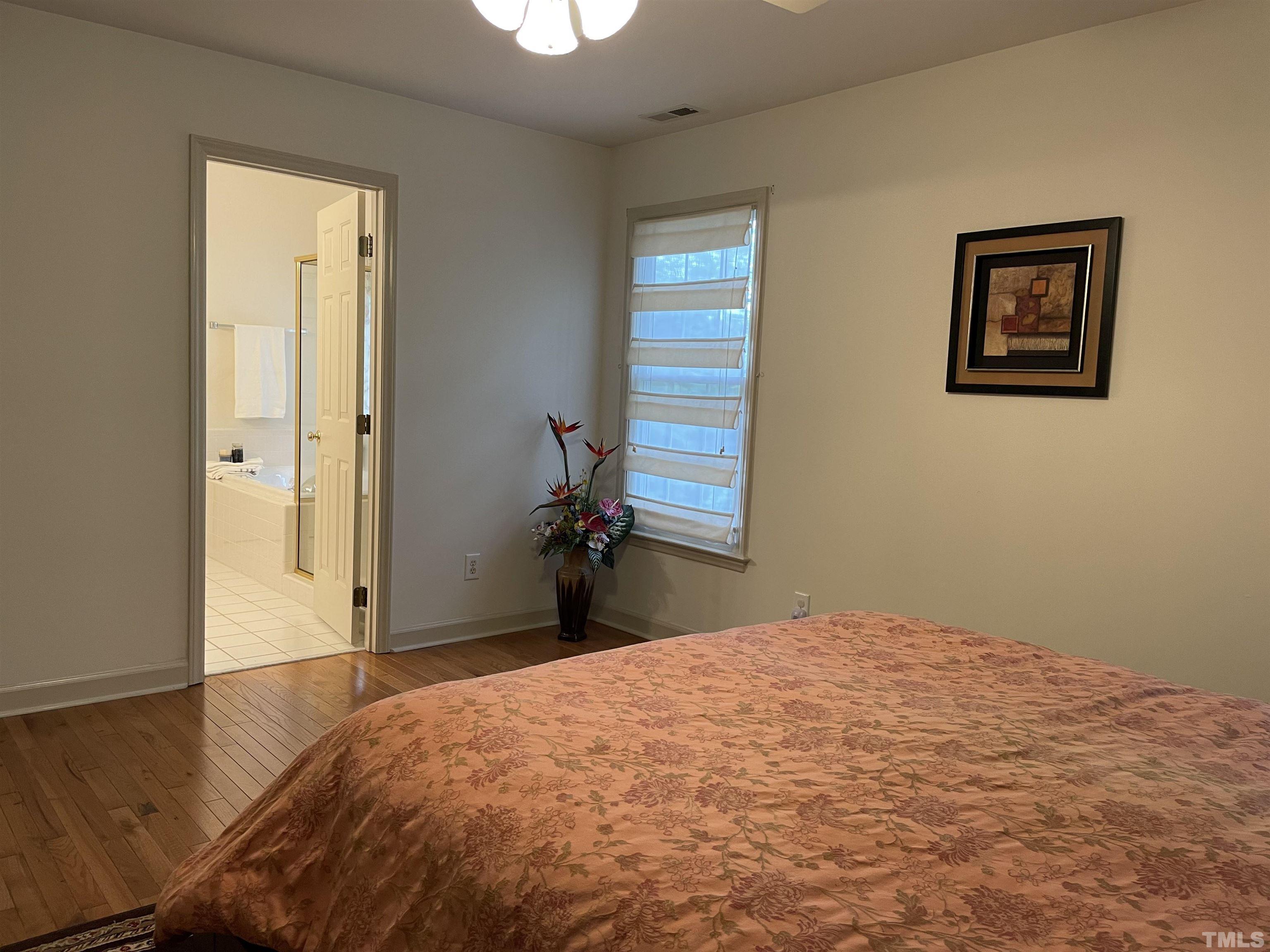 3401 Savan Court Raleigh, NC 27613 - Photo 16 of 27 a bedroom with a bed and a window