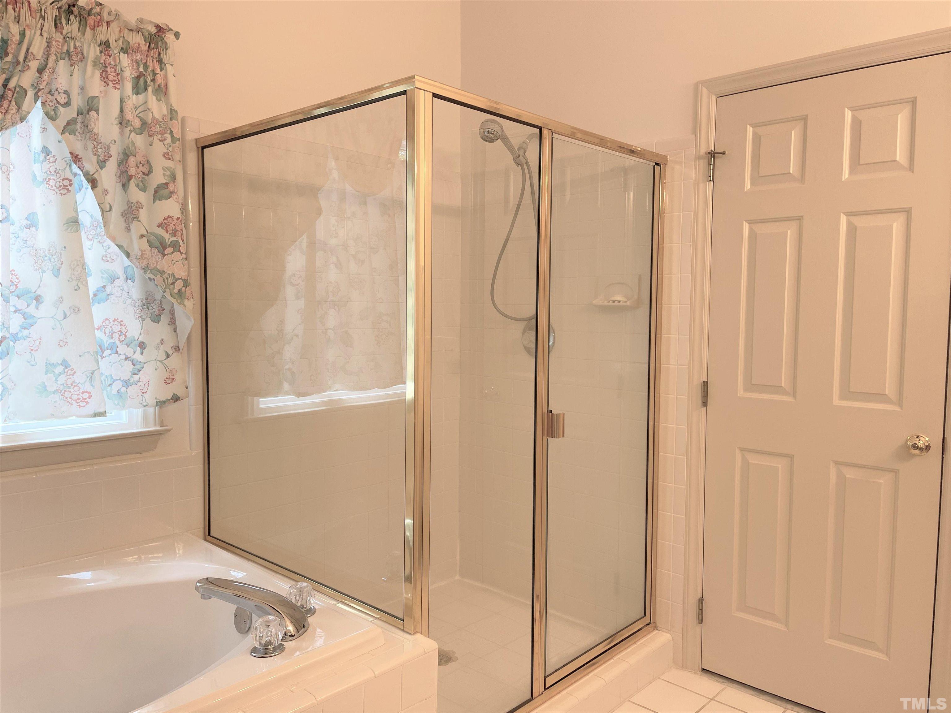 3401 Savan Court Raleigh, NC 27613 - Photo 18 of 27 a bathroom with a shower and a tub