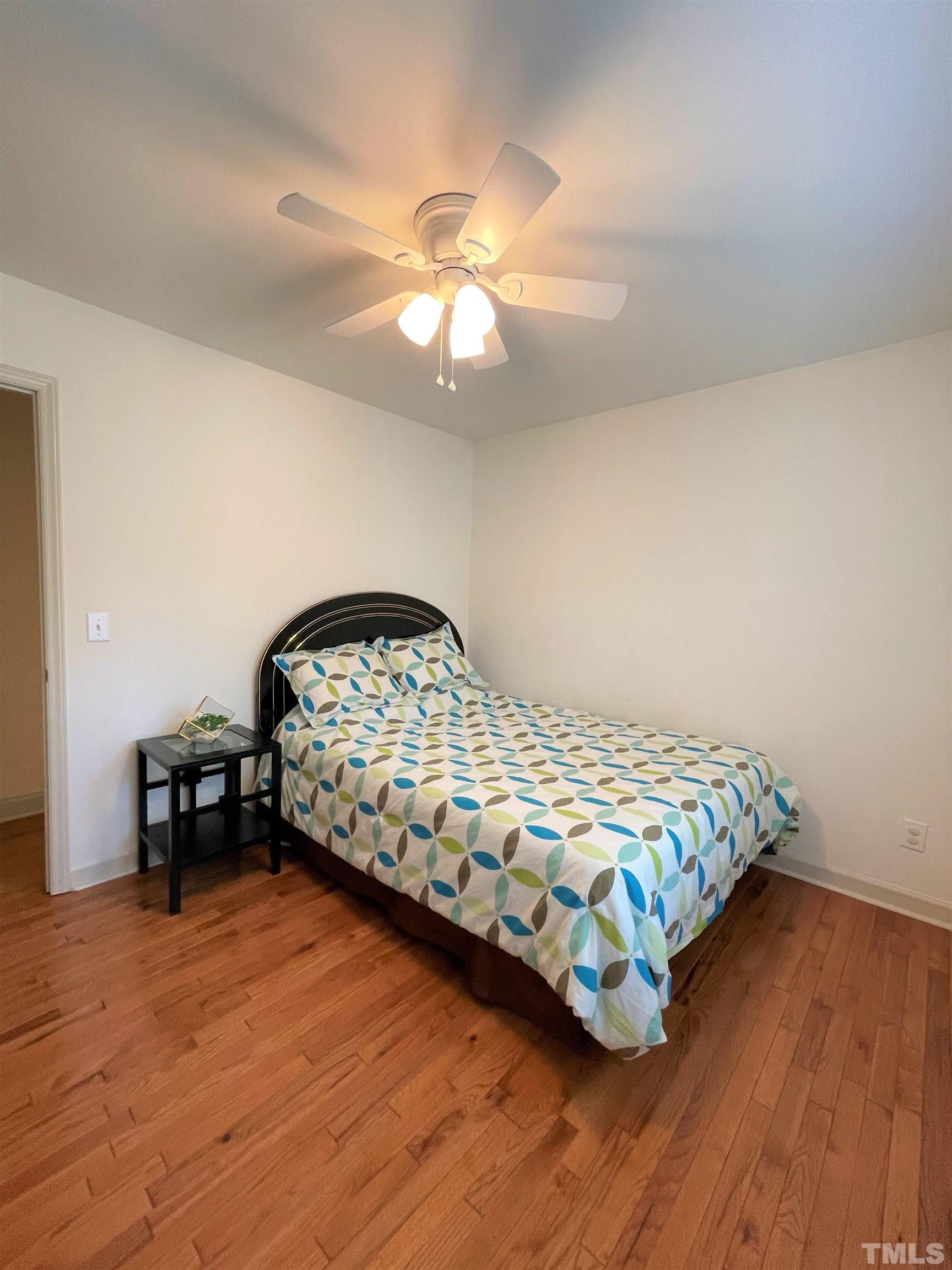 3401 Savan Court Raleigh, NC 27613 - Photo 21 of 27 a bedroom with a bed and wooden floor