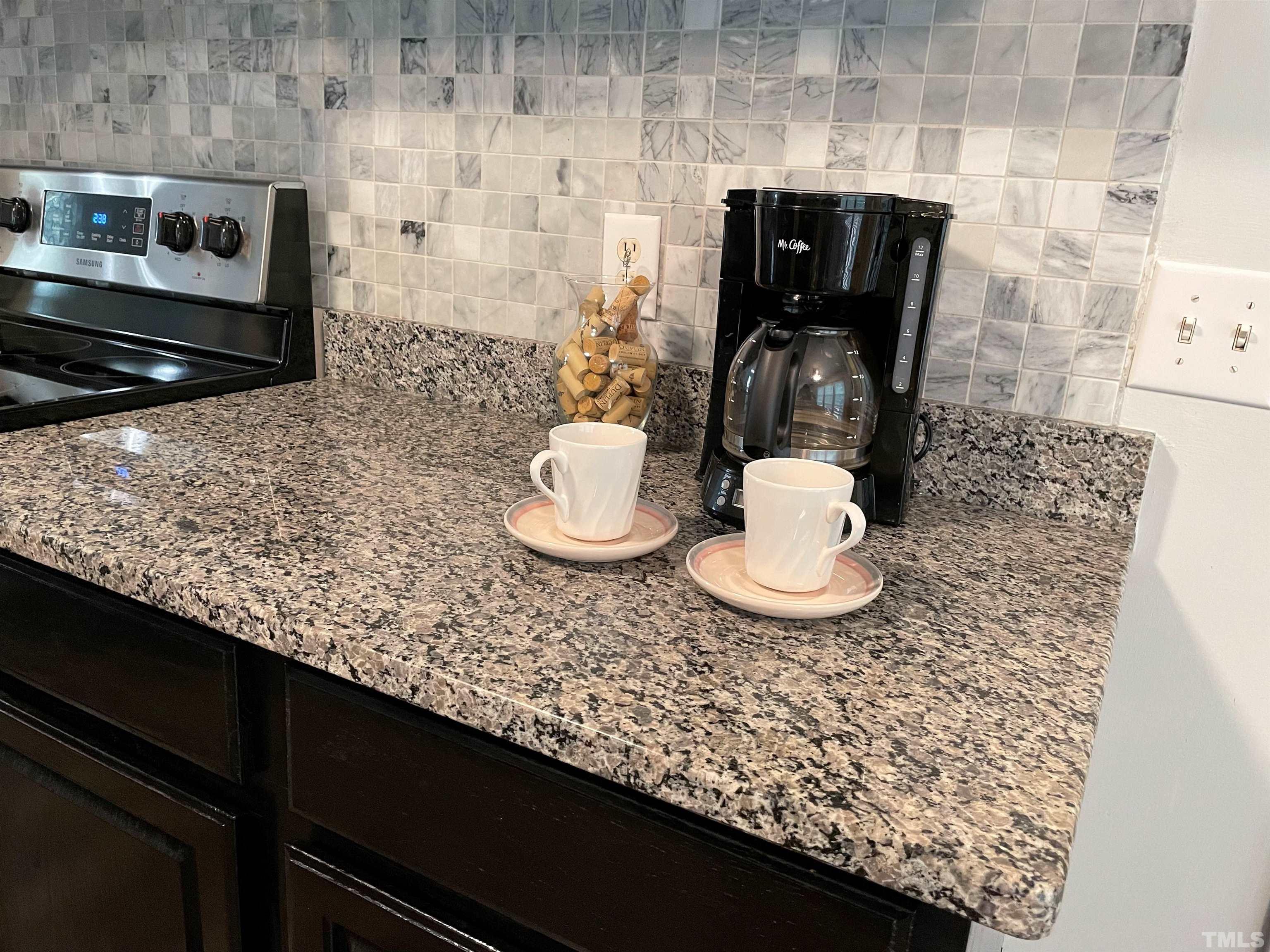 3401 Savan Court Raleigh, NC 27613 - Photo 10 of 27 a kitchen with a table and a stove