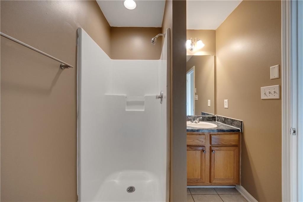 4203 Legacy Square Atlanta, GA 30349 - Photo 30 of 35 a bathroom with a mirror sink and vanity