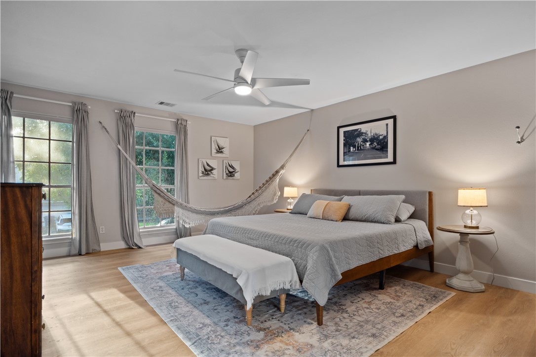 7654 Timber Crest Drive Corpus Christi, TX 78413 - Photo 20 of 35 a bedroom with a bed a lamp and potted plant