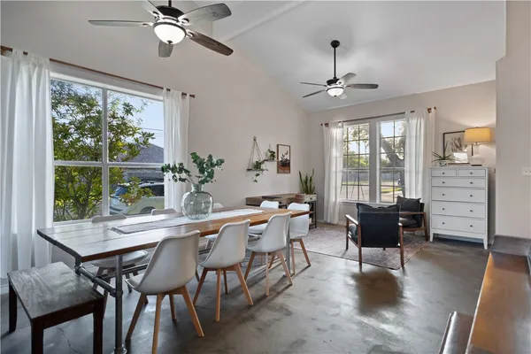 a dining room with furniture window and wooden floor