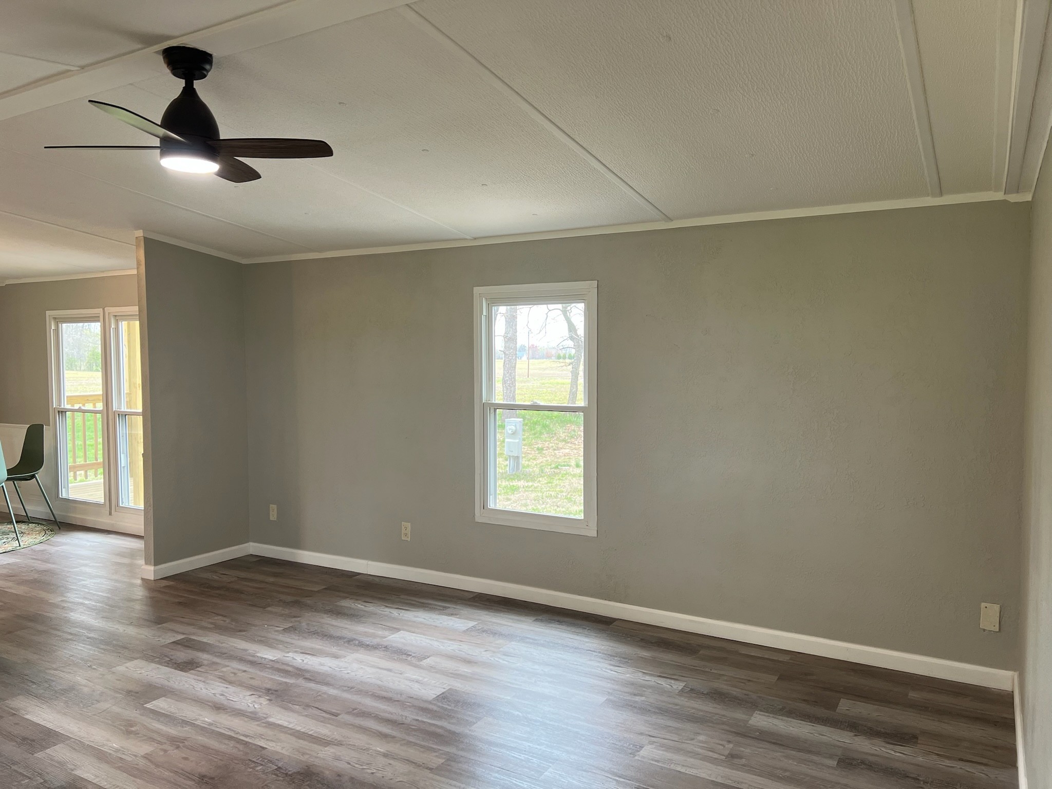 511 Hall-Leffew Road Franklin, KY 42134 - Photo 12 of 26 an empty room with wooden floor chandelier fan and windows