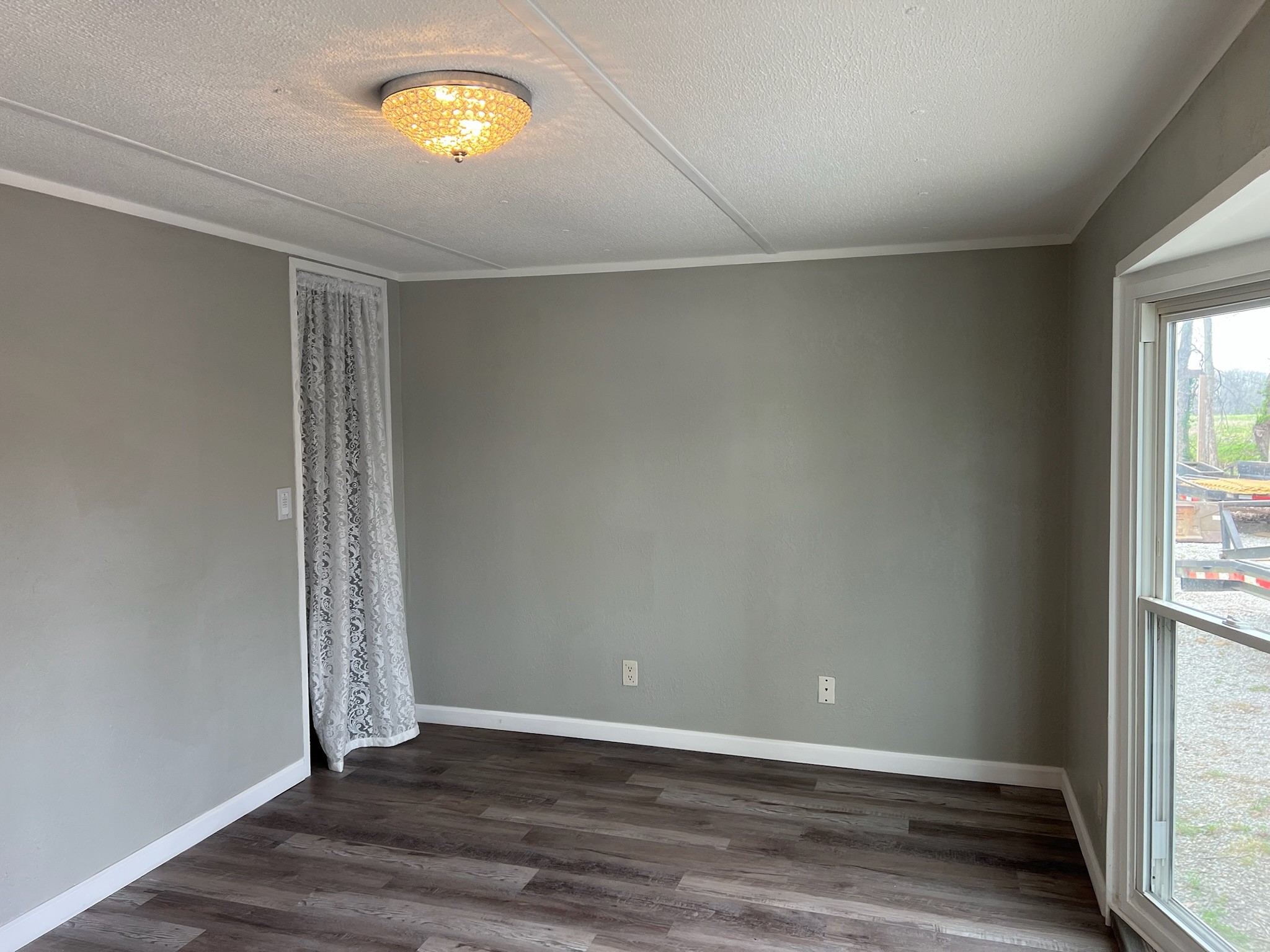 511 Hall-Leffew Road Franklin, KY 42134 - Photo 16 of 26 an empty room with wooden floor and windows