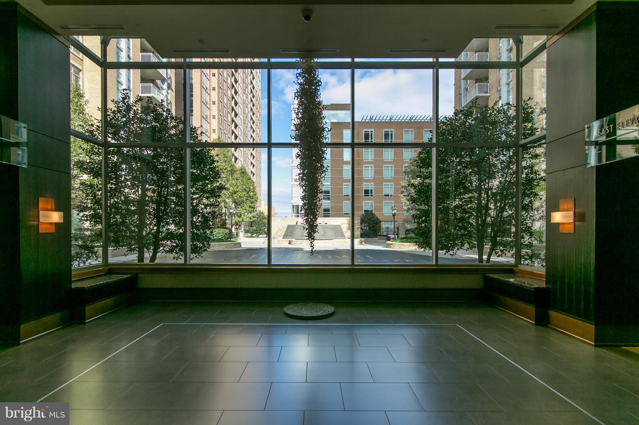 11990 Market Street, Unit 1712 Reston, VA 20190 - Photo 3 of 16 Lobby with view of pool and landscaped patio